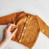 Gold newborn cardigan made from The Old Horizon's knitting pattern