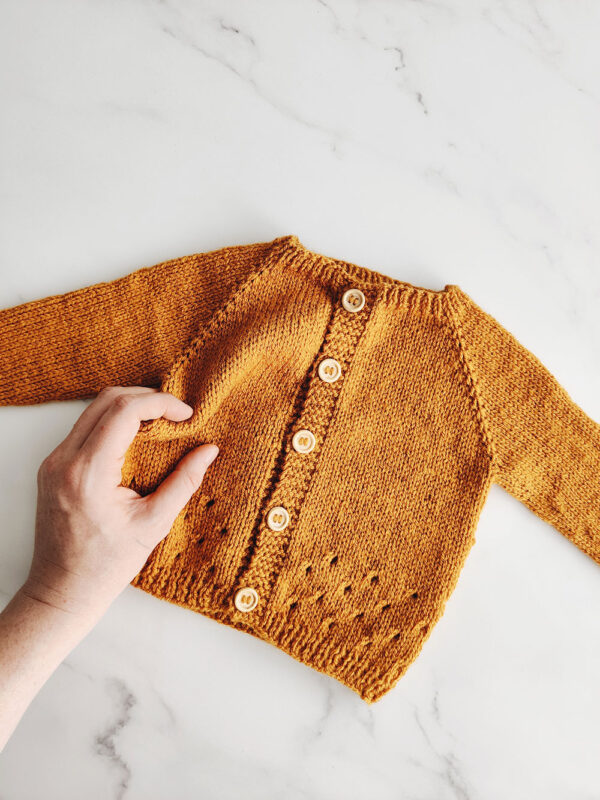 Gold newborn cardigan made from The Old Horizon's knitting pattern