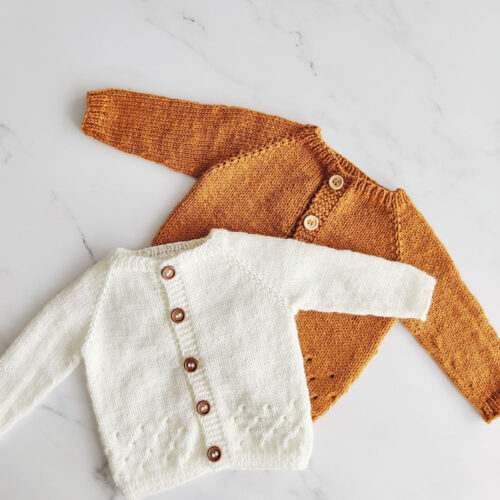 White and gold cardigans made from the Angus Baby Cardigan knitting pattern