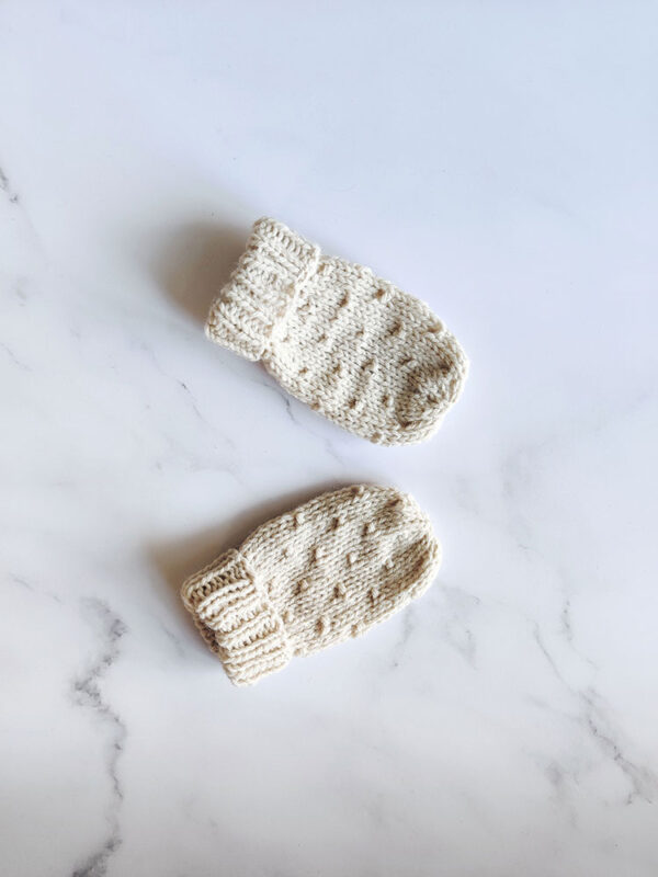 Pair of knitted thumbless baby mittens