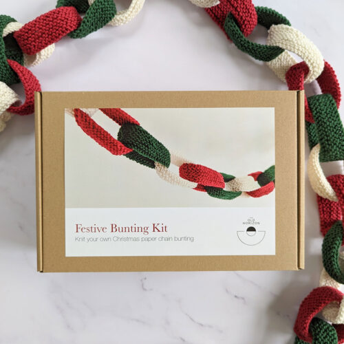 Christmas bunting knit kit with knitted paper chain bunting in red, white and green