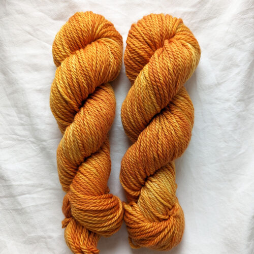 Two skeins of golden brown chunky superwash yarn