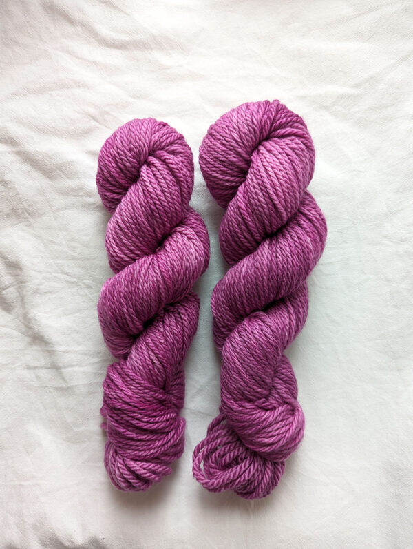 Two skeins of purple hand dyed yarn in chunky weight