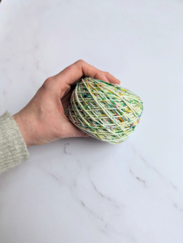 Winded confetti speckled yarn by The Old Horizon featuring blue, green, yellow and pink speckles