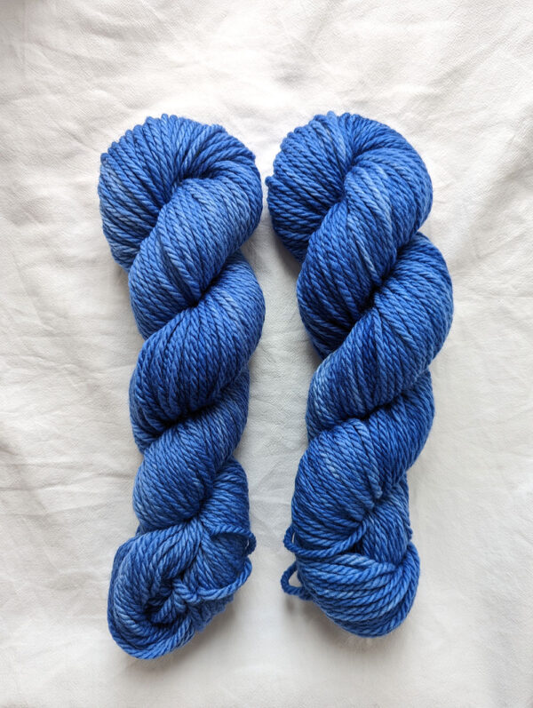 Two skeins of vivid blue chunky hand dyed yarn in superwash merino
