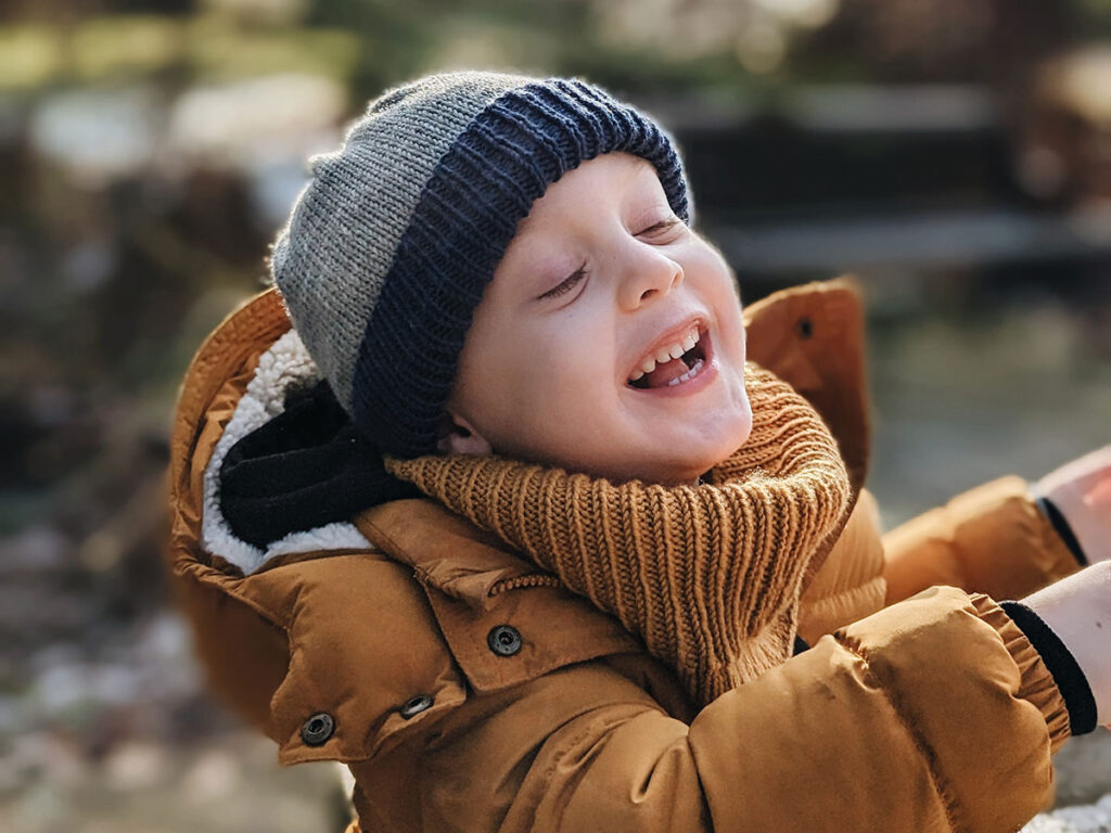 Free childrens snood knitting pattern - child wearing knitted rib cowl in mustard in size 4-6 years