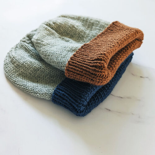 Knitted beanie hat in grey, brown and navy. Made from Tideswell Hat knitting pattern for all ages