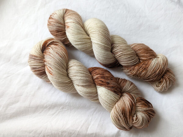 Two skeins of brown speckled yarn in 4ply weight