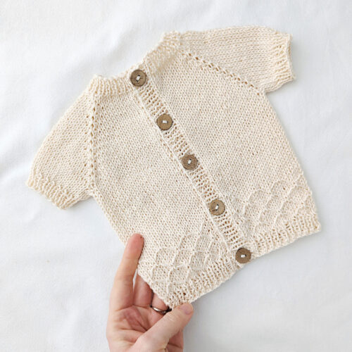 Summer baby cardigan knitted in cotton yarn with short sleeves
