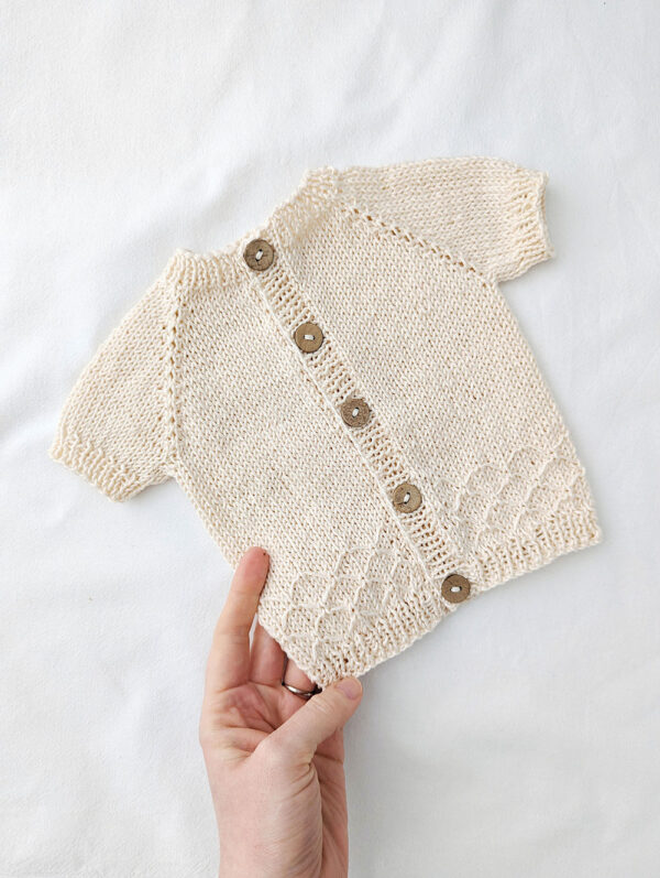 Summer baby cardigan knitted in cotton yarn with short sleeves