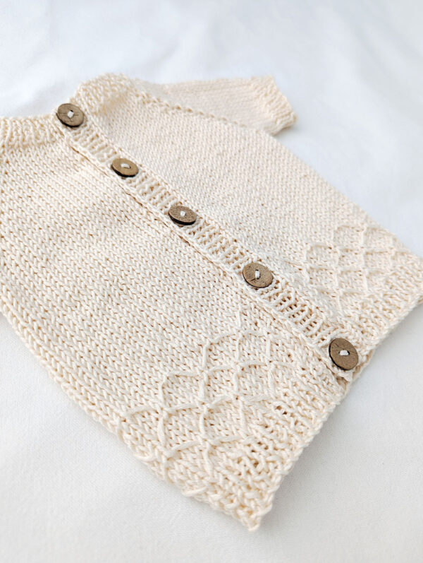 Patterned knitted baby summer cardigan in off white with rib boarders
