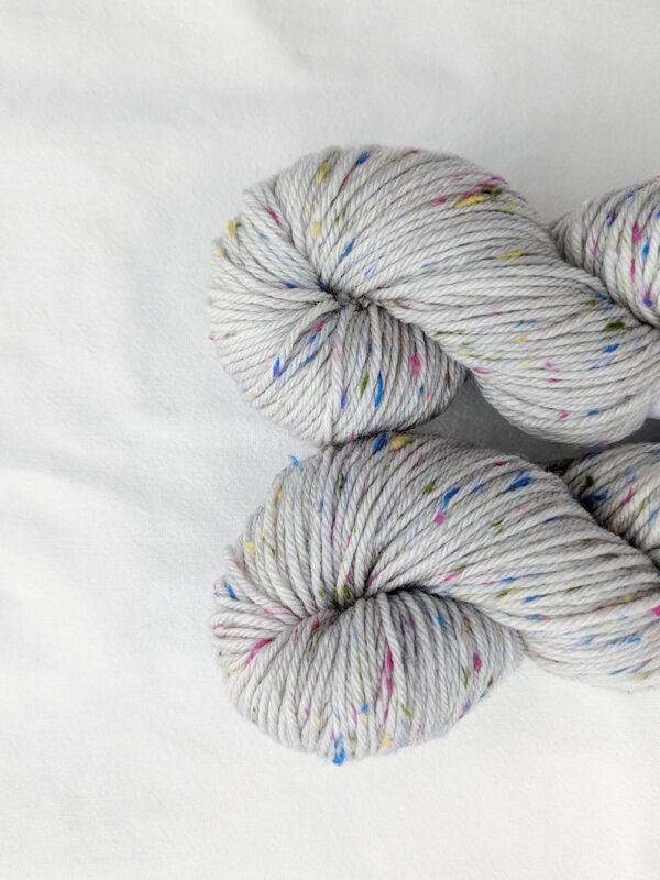 Grey yarn with multi coloured tweed specs in dk weight