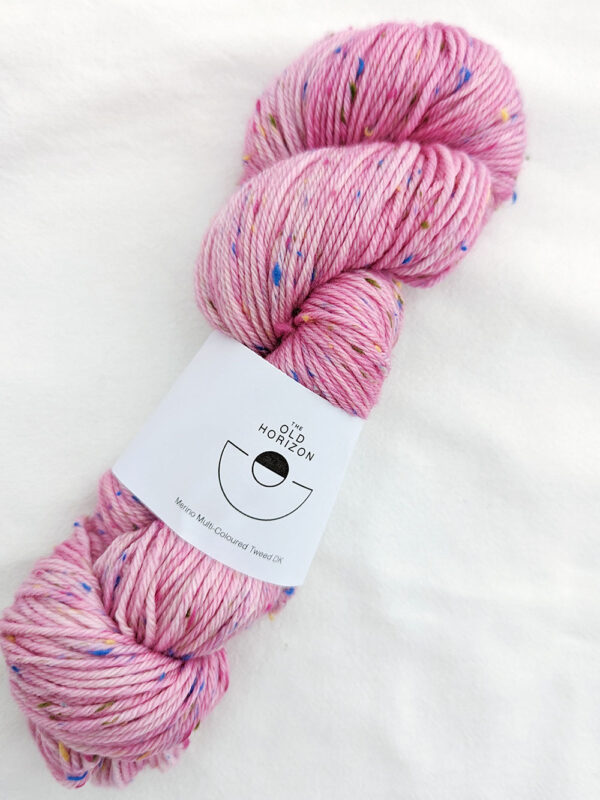 Skein of pink yarn with multi coloured tweed specs